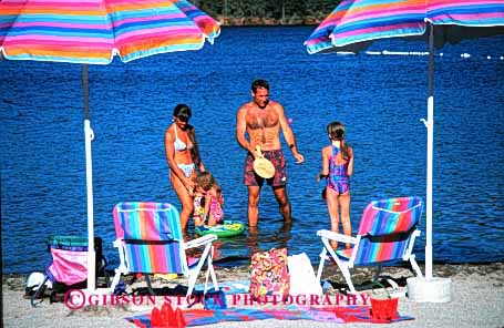 Stock Photo #2568: keywords -  beach child children family father horz lake mother parent play recreation released summer sunshine together umbrella vacation