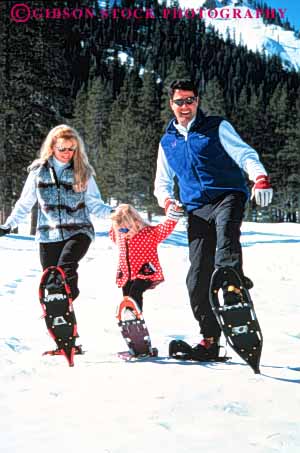 Stock Photo #3374: keywords - adventure affection child cooperation daughter exercise families family fun girl husband released smile snow snowshoe sport together vert wife winter
