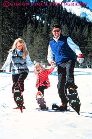 Stock Photo #3374: keywords -  adventure affection child cooperation daughter exercise families family fun girl husband released smile snow snowshoe sport together vert wife winter