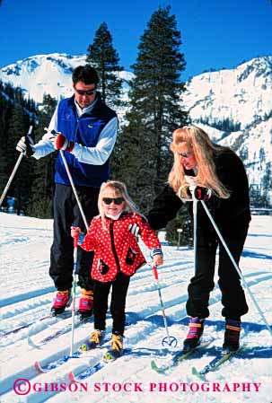 Stock Photo #2579: keywords -  child country cross family father fun girl mother nordic parent play recreation released share ski snow sport together vert winter