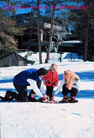 Stock Photo #2580: keywords - child family father fun girl mother parent play recreation released share snow snowshoe sport together vert winter
