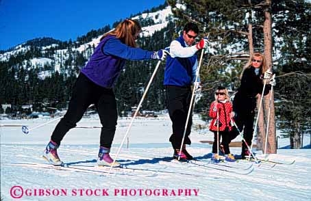 Stock Photo #2590: keywords -  child class country cross family father fun girl horz learn lesson mother parent play practice recreation released share ski snow sport teach together winter