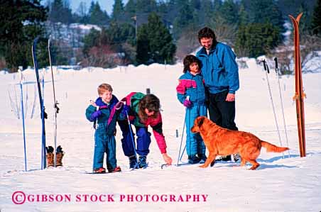 Stock Photo #2591: keywords -  children country cross dog family father fun horz mother parent play recreation released share ski snow sport together winter