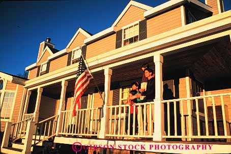 Stock Photo #2595: keywords -  american boy children family father flag home horz house husband mother porch read released son together wife