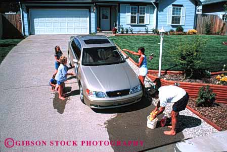 Stock Photo #2599: keywords - auto bucket car children clean family fun home horz hose house parent play released residential summer together vehicle wash water wet