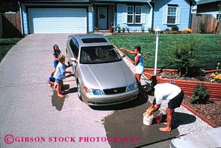 Stock Photo #2599: keywords -  auto bucket car children clean family fun home horz hose house parent play released residential summer together vehicle wash water wet