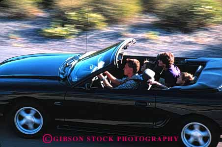 Stock Photo #2601: keywords - auto blur car children convertible drive family horz husband motion move parent released street summer together travel vehicle