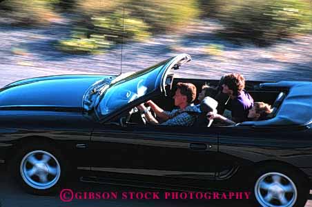 Stock Photo #2601: keywords -  auto blur car children convertible drive family horz husband motion move parent released street summer together travel vehicle