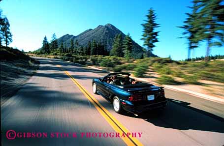 Stock Photo #2602: keywords -  auto blur car children convertible drive family horz husband motion move parent released street summer together travel vehicle