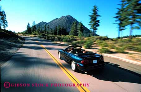 Stock Photo #2602: keywords - auto blur car children convertible drive family horz husband motion move parent released street summer together travel vehicle
