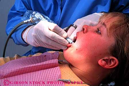 Stock Photo #2731: keywords - adolescent care career child citizen dental dentist dentistry doctor examine girl horz job medical mouth occupation patient profession released skill teeth training vocation work