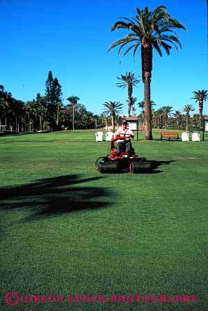 Stock Photo #2774: keywords -  drive equipment golf green groom grounds job landscape lawn machine maintenance man occupation operator tractor vert work