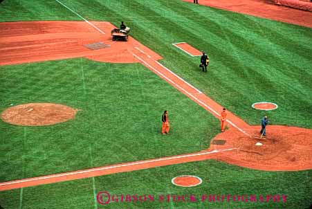 Stock Photo #2777: keywords -  baseball diamond green groom grounds horz hose irrigation job landscape men occupation repair team work