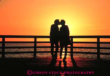 Stock Photo #3447: keywords -  affection close couple couples horz hug intimate kiss love outdoor private quiet relax security share silhouette sunset together vacation warm