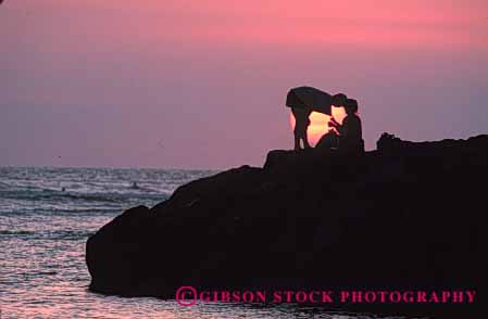 Stock Photo #2814: keywords -  alone calm couple dusk hawaii horz intimate love ocean orange peaceful quiet romantic share silhouette solitude summer sunset together vacation warm water yellow