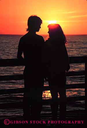 Stock Photo #2816: keywords -  alone calm couple dusk intimate love not ocean orange peaceful quiet released romantic share silhouette solitude summer sunset together vacation vert warm water yellow young