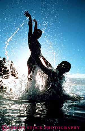 Stock Photo #3450: keywords -  close couple couples fun help joy jump lift play released share silhouette splash summer swim together tropic tropical vacation vert warm