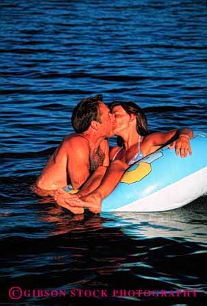 Stock Photo #2823: keywords -  affection beach calm couple fun honeymoon husband intimate kiss love ocean play private released share solitude summer sun sunshine swim tan together travel tube vacation vert water wife