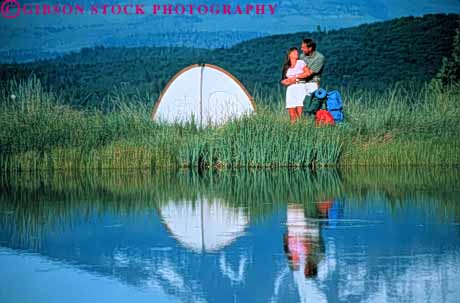 Stock Photo #3453: keywords -  adventure affection backpack camp close cooperate couple couples explore grass hike horz hug intimate lake love outdoor peace private quiet reflection released share snuggle solitude summer tent together