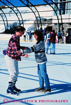 Stock Photo #2830: keywords -  affection couple fun husband ice intimate not play released share skate skating sun sunshine together travel vert wife winter