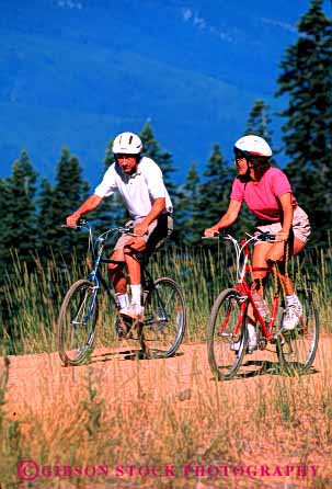 Stock Photo #2836: keywords -  affection alone bicycle bike couple fun helmet husband intimate play private released share solitude summer sun sunshine together travel vert wife wilderness