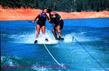 Stock Photo #2849: keywords -  action affection alone board couple fun horz husband intimate kiss lake motion play private released share ski skill solitude summer sun sunshine together travel wake water wife