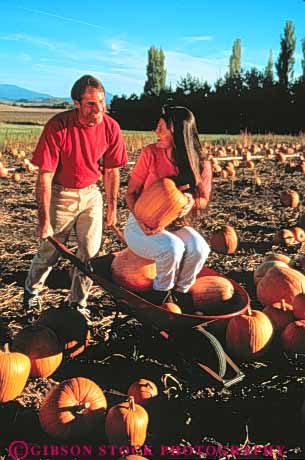 Stock Photo #3454: keywords -  affection autumn california close cooperate couple couples fall fun granada harvest joy outdoor pick play pumpkin released ride share team together vert wheelbarrow