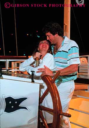 Stock Photo #2855: keywords - affection boat couple hug husband intimate love night released sail share ship summer together travel vacation vert wheel wife