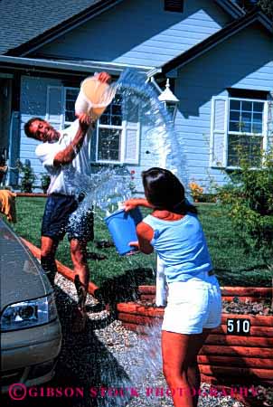 Stock Photo #2869: keywords -  affection bucket car couple fight fun husband intimate love play released share splash summer throw together vert wash water wet wife