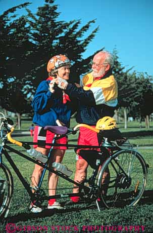 Stock Photo #3459: keywords -  assist bicycle bike cooperate couple couples equipment exercise helmet outdoor released ride senior share summer tandem team vert