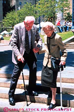 Stock Photo #6116: keywords - assist canes careful caution citizen couple elderly help mature old senior seniors slow slowly step steps timers vert walk with