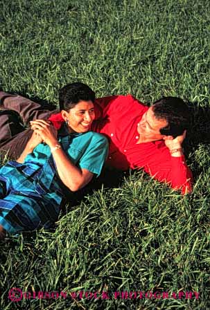 Stock Photo #2893: keywords -  affection chicano colorful couple grass hispanic husband intimate lawn love mexican minority relax released share smile together vert wife