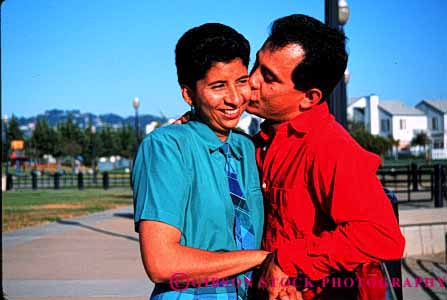 Stock Photo #2896: keywords - affection chicano colorful couple hispanic horz hug husband intimate kiss love mexican minority released share smile together wife