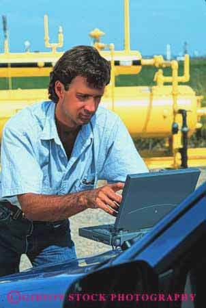 Stock Photo #2940: keywords -  battery business casual compute computer computers data equipment field industrial laptop man outdoor outdoors outside portable powered process released remote site technician technology using vert