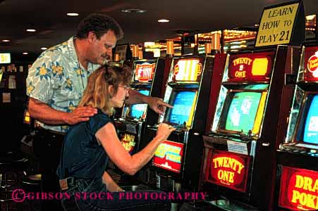 Stock Photo #2979: keywords -  bet casino chance couple gamble gambling game horz loose machine odds released risk share slot together vacation win