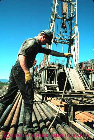 Stock Photo #3040: keywords -  dirt drill drilling employee hard hardhat industry job labor man not oil outdoor physical released rig vert work working