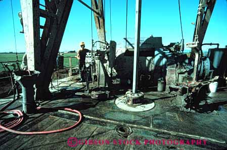 Stock Photo #3043: keywords -  dirt drill drilling employee hard hardhat horz industry job labor man oil outdoor physical rig work