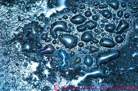 Stock Photo #3428: keywords -  abstract close-up drop horz iridescence iridescent oil pollution prism reflection round street water