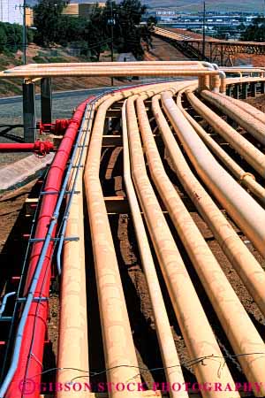 Stock Photo #4112: keywords -  identical industry parallel pattern petroleum pipe refinery round same symmetry vert