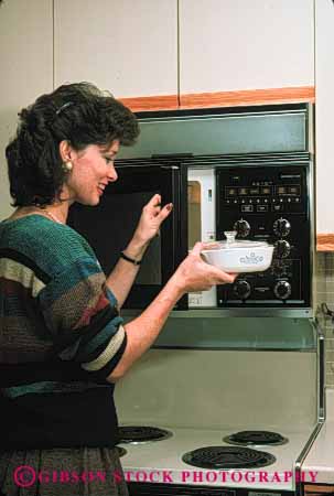Stock Photo #4113: keywords -  appliance cook cooking food home kitchen microwave prepare process released vert woman