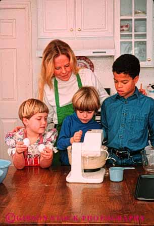 Stock Photo #4114: keywords -  african american appliance bake baking black boy child children cook cooking ethnic food girl group home kitchen minority mother prepare process racial recipe released share team together vert woman