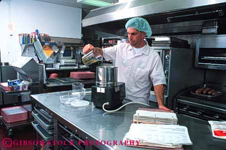 Stock Photo #4116: keywords -  appliance cook cooking employee food horz hospital institution job kitchen labor man metal occupation pour prepare process profession released service stainless steel