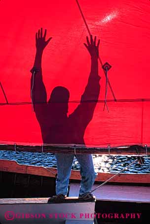 Stock Photo #4149: keywords -  abstract contrast dark light man red sail shadow silhouette vert