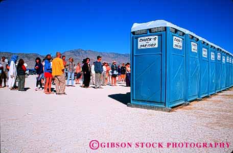 Stock Photo #4188: keywords -  building crowd desert horz houses line out outhouse outhouses people plastic restroom row shack toilet wait waiting