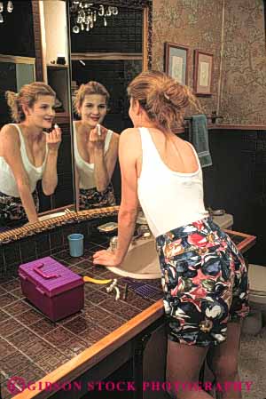 Stock Photo #4228: keywords -  appearance apply beauty cosmetic esteem home looks make mirror preparation reflection released self smile teenage teenager up vert woman young