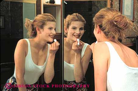 Stock Photo #4229: keywords -  appearance apply beauty cosmetic esteem home horz looks make mirror preparation reflection released self smile teenage teenager up woman young