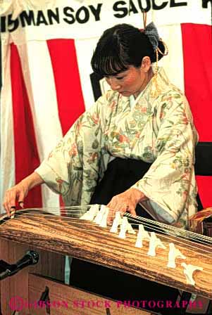 Stock Photo #4248: keywords - annual asian blossom celebrate celebration cherry color colorful dance display ethnic event festival francisco instrument japanese japantown koto minority music performance play san show string together tradition unity vert woman