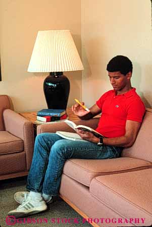 Stock Photo #4263: keywords - adult african american black college concentrate educate education ethnic high homework learn male man minority read released school student study vert