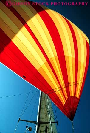 Stock Photo #4354: keywords -  air boat boating bright color colorful craft float mast recreation red sail strip striped toy vert vessel water wind yellow