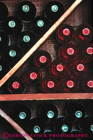 Stock Photo #4359: keywords - alcohol bottle bottles clear container cylinder display drink glass pattern rack red round row storage symmetrical symmetry vert wine